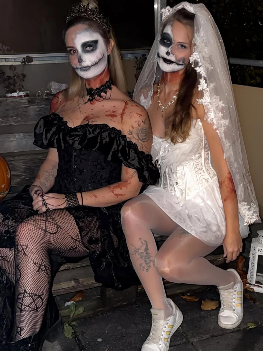 black outfit with off-shoulder fitted black shape beside short light dress and veil