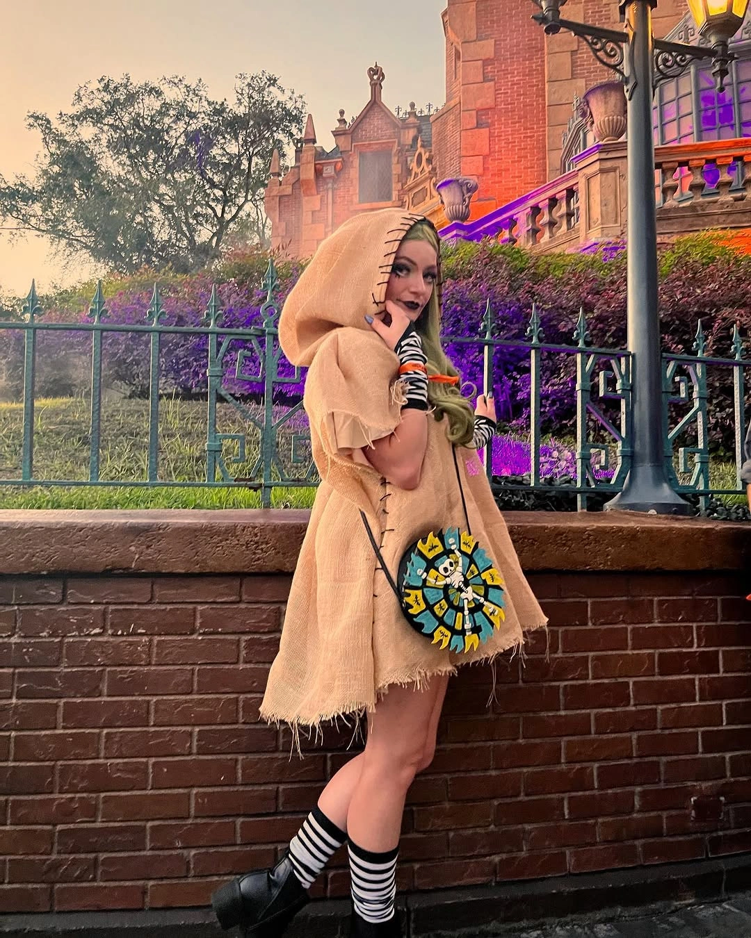 tan outfit with short loose hooded layer with bare-leg gap and striped socks