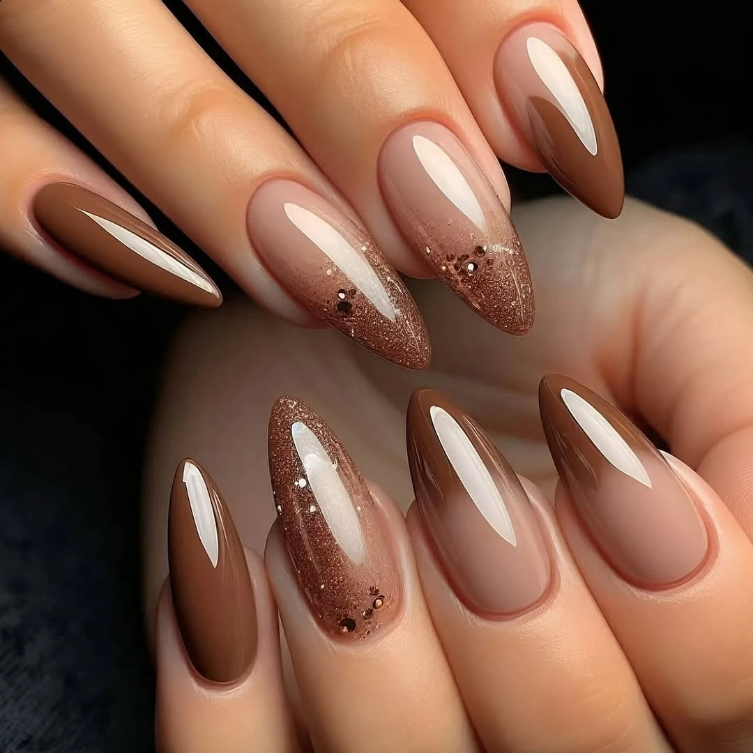 long almond neutral nails with a soft glitter accent