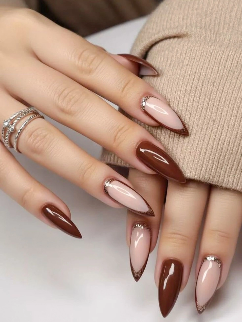 long almond nails with blush brown tips and gold borders