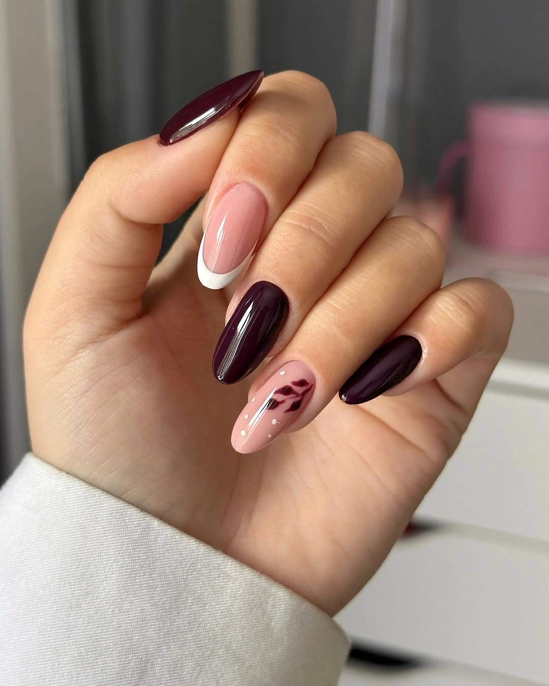 medium almond plum nails with one pale floral accent