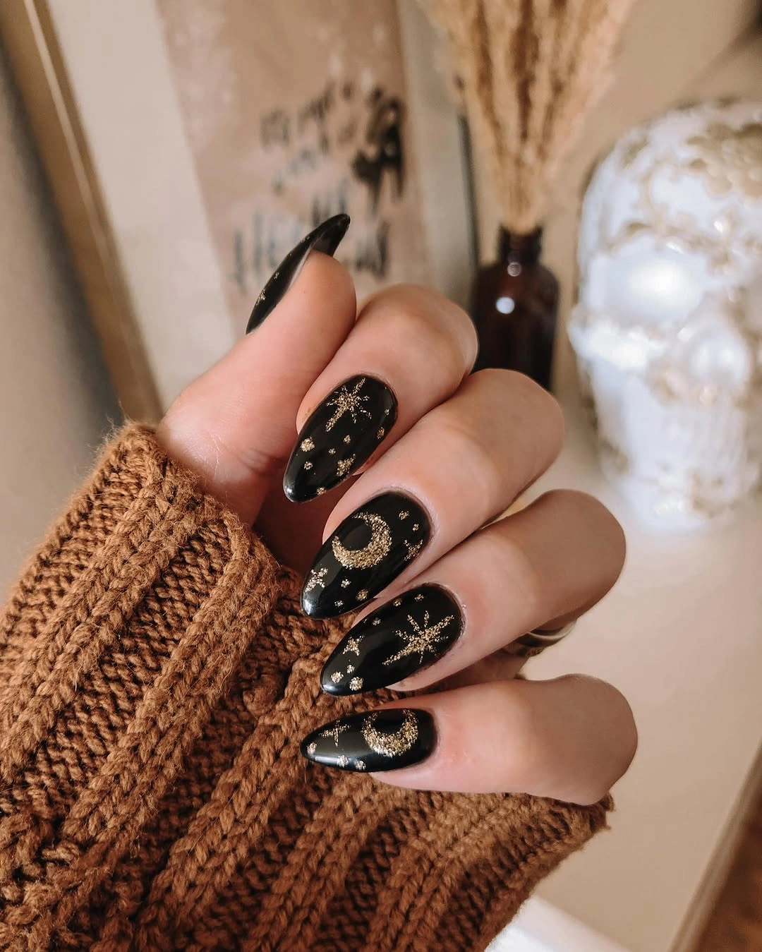 long black almond nails with small gold celestial accents