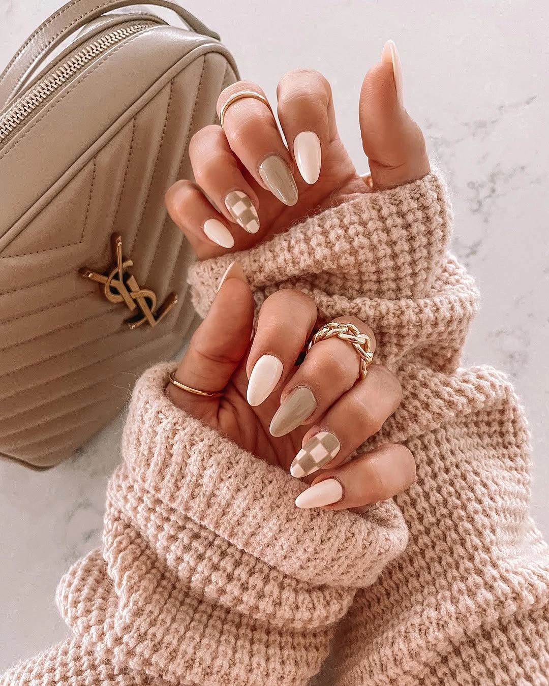 long almond cream nails with taupe checkerboard accents