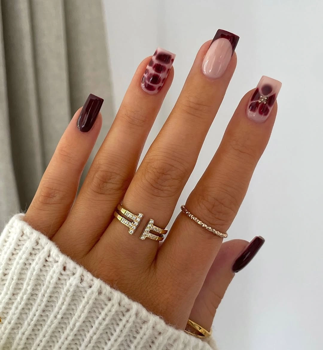 medium square burgundy nails with a tortoiseshell accent