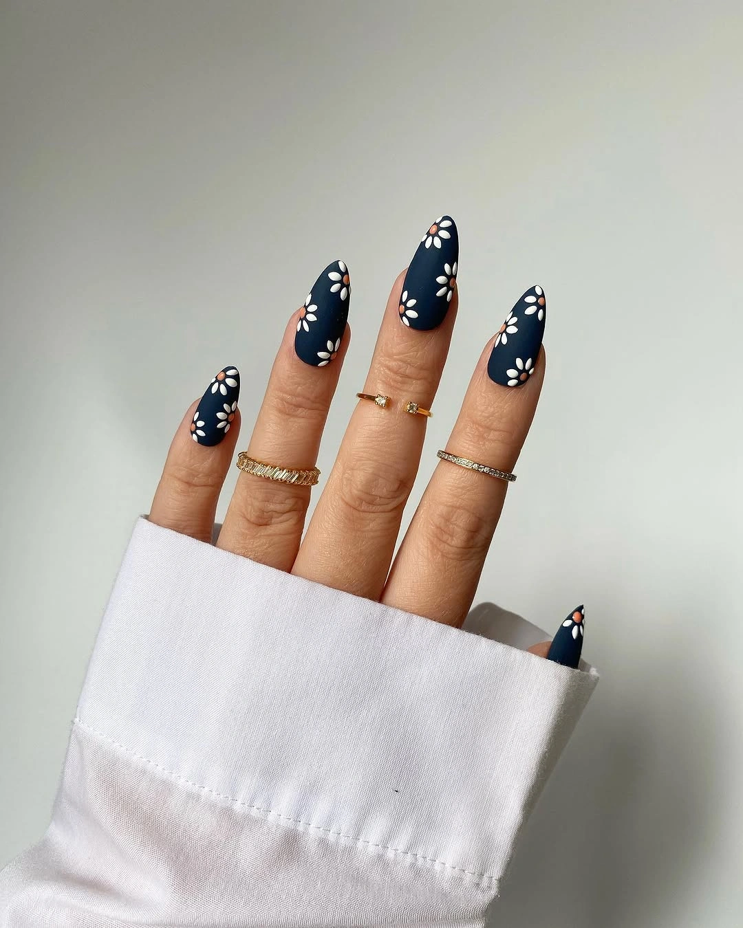 long navy almond nails with small white flowers