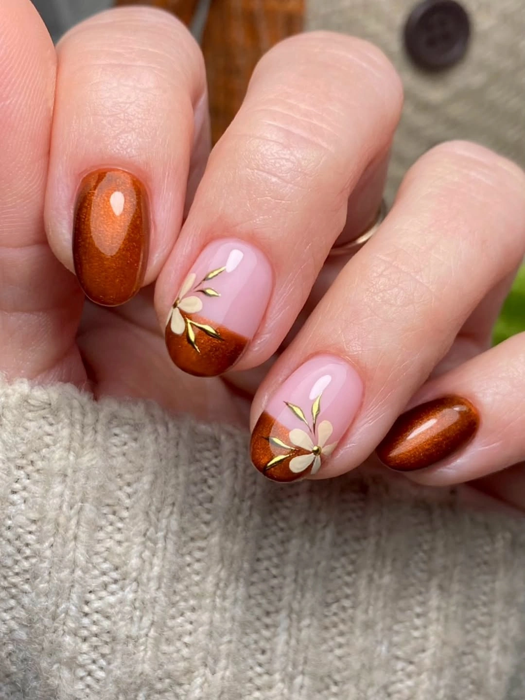 Short orange nails with blush floral accent details