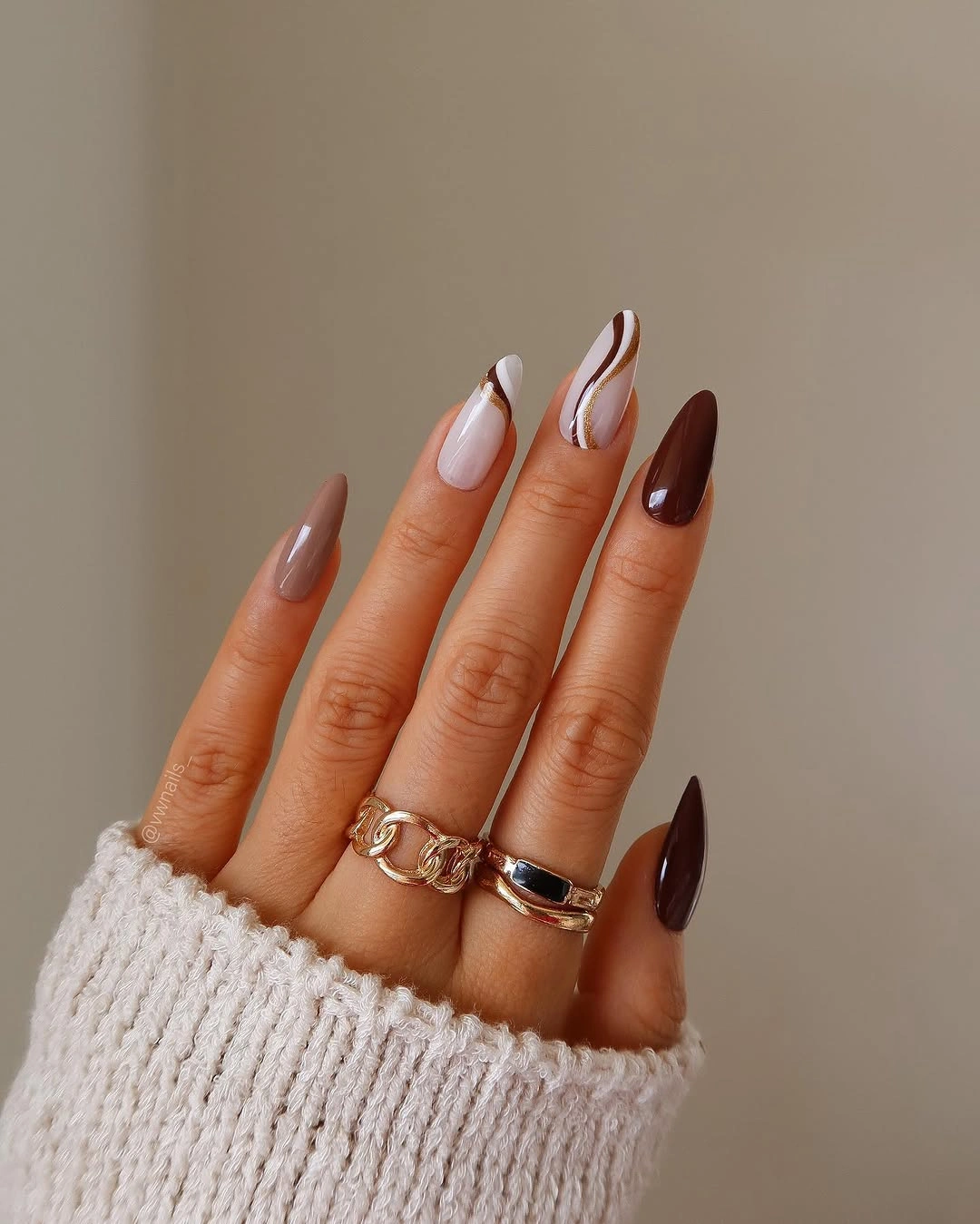 Nude swirl and burgundy almond nails