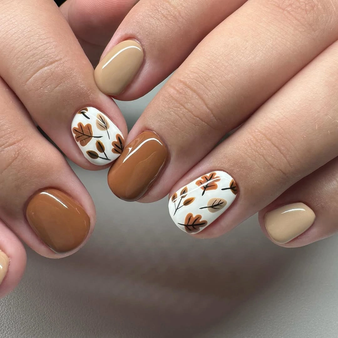 Short caramel nails with brown leaf art