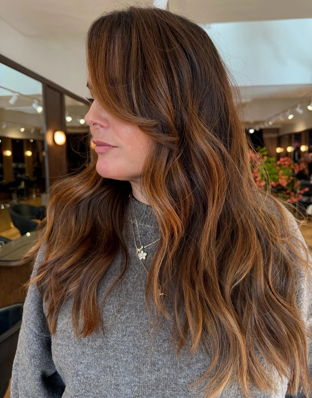 long brown layers with a warm face-framing highlight