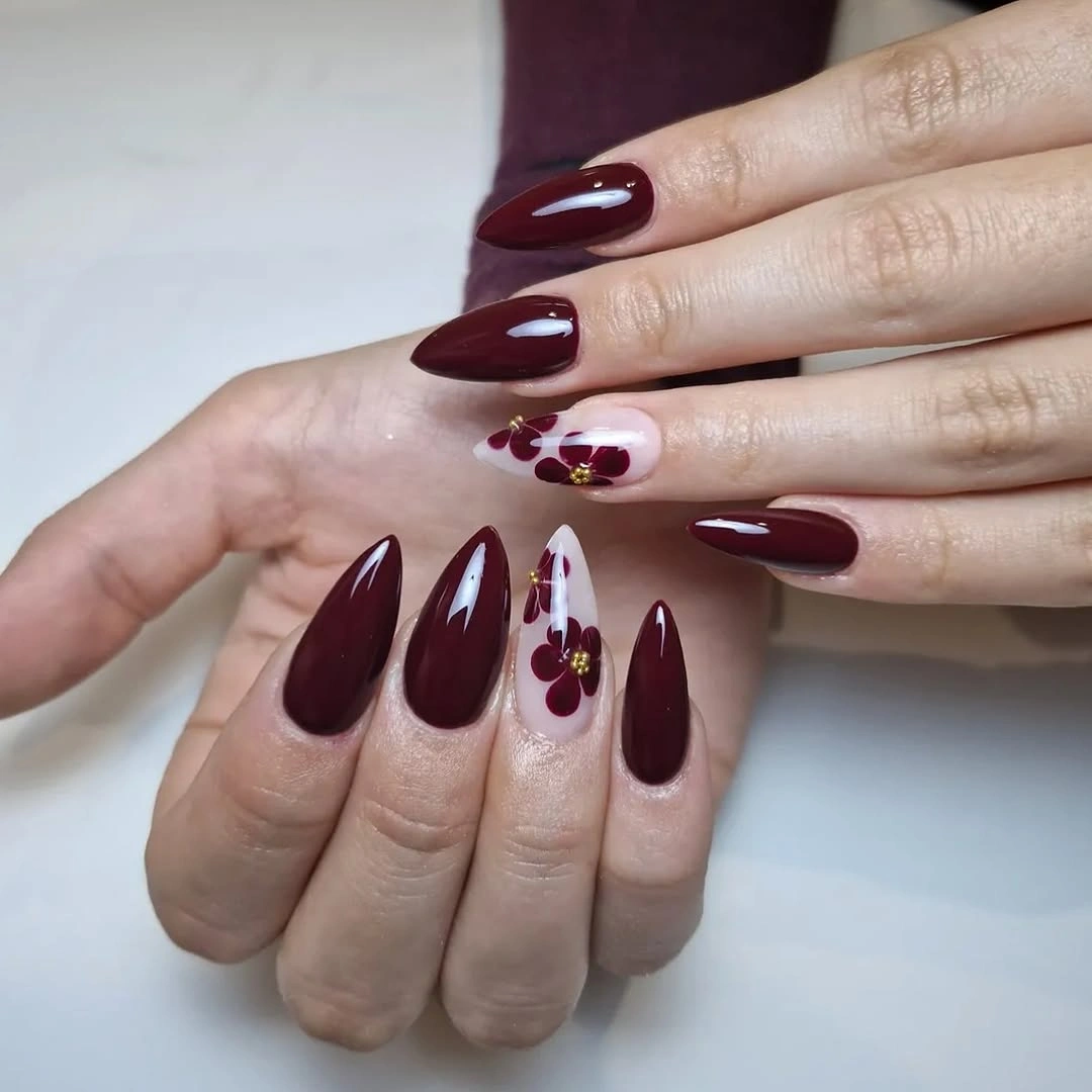 long burgundy stiletto nails with pale floral accents