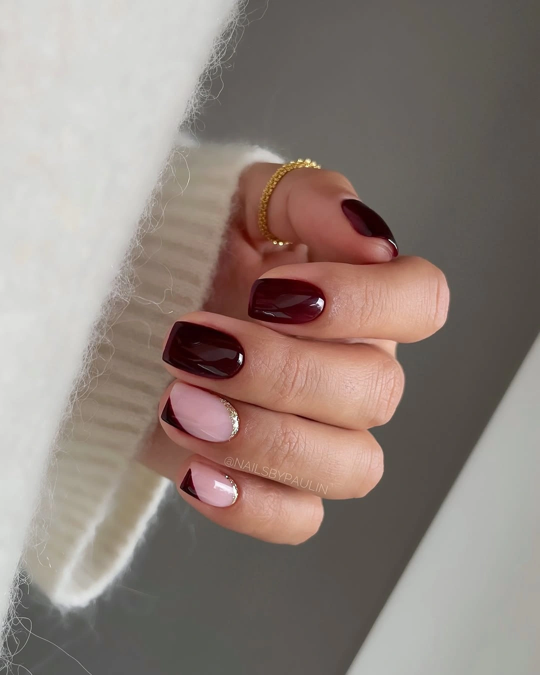medium square burgundy nails with nude gold foil accents