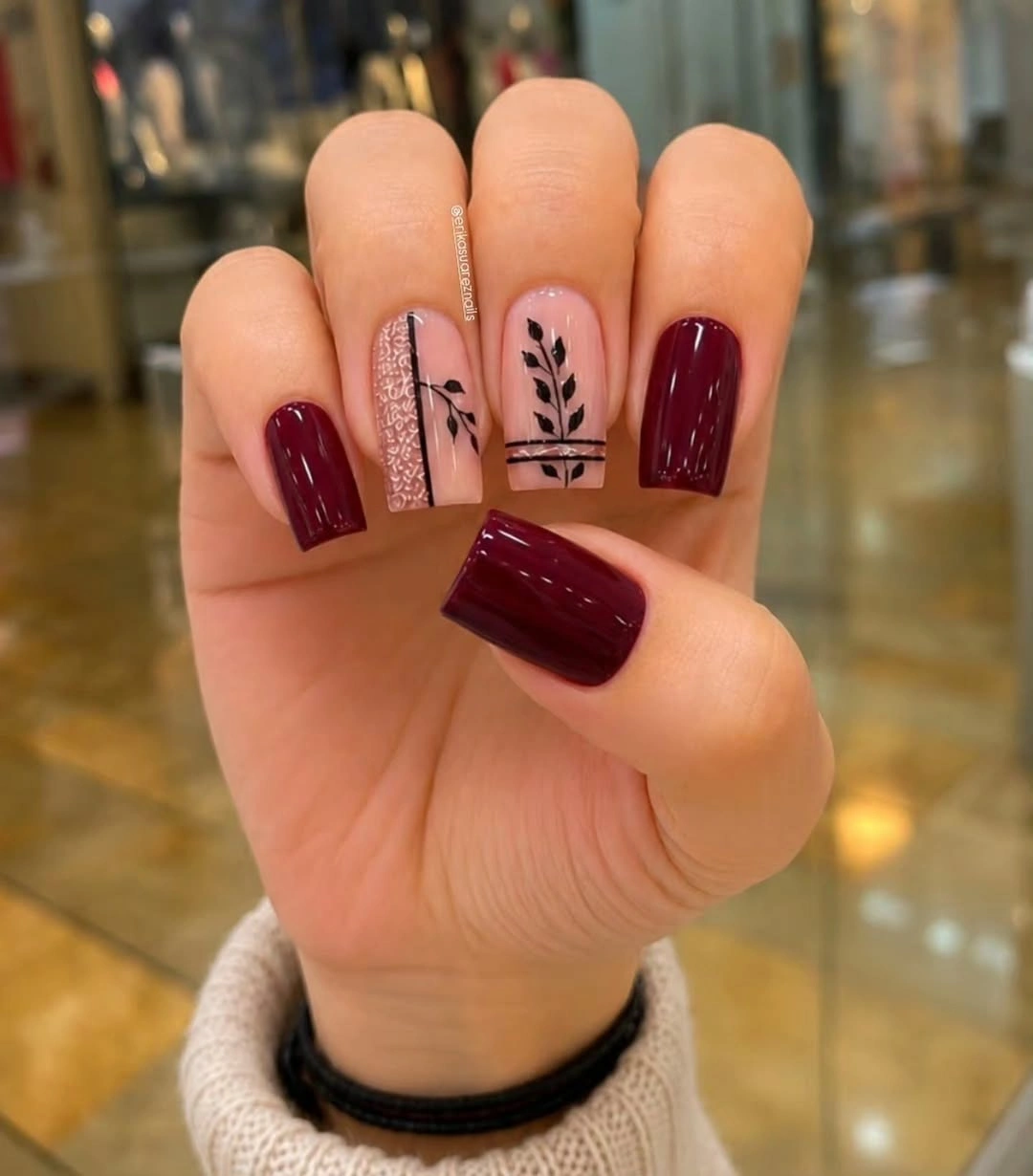 short square burgundy nails with nude botanical line accents