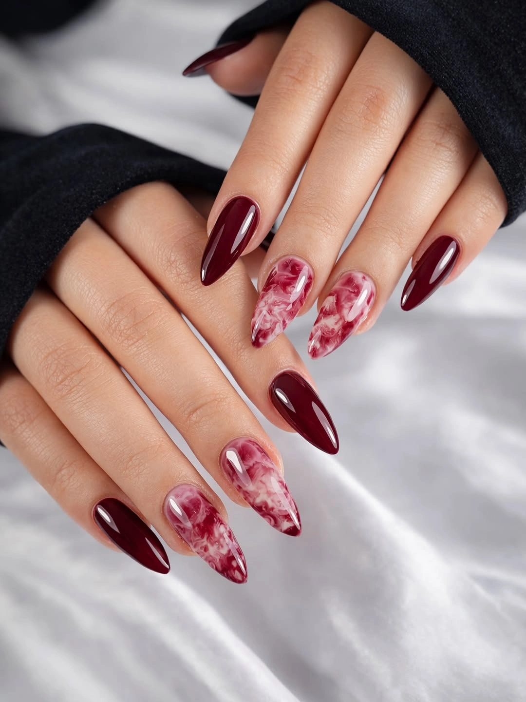 long burgundy stiletto nails with pale pink marble accents