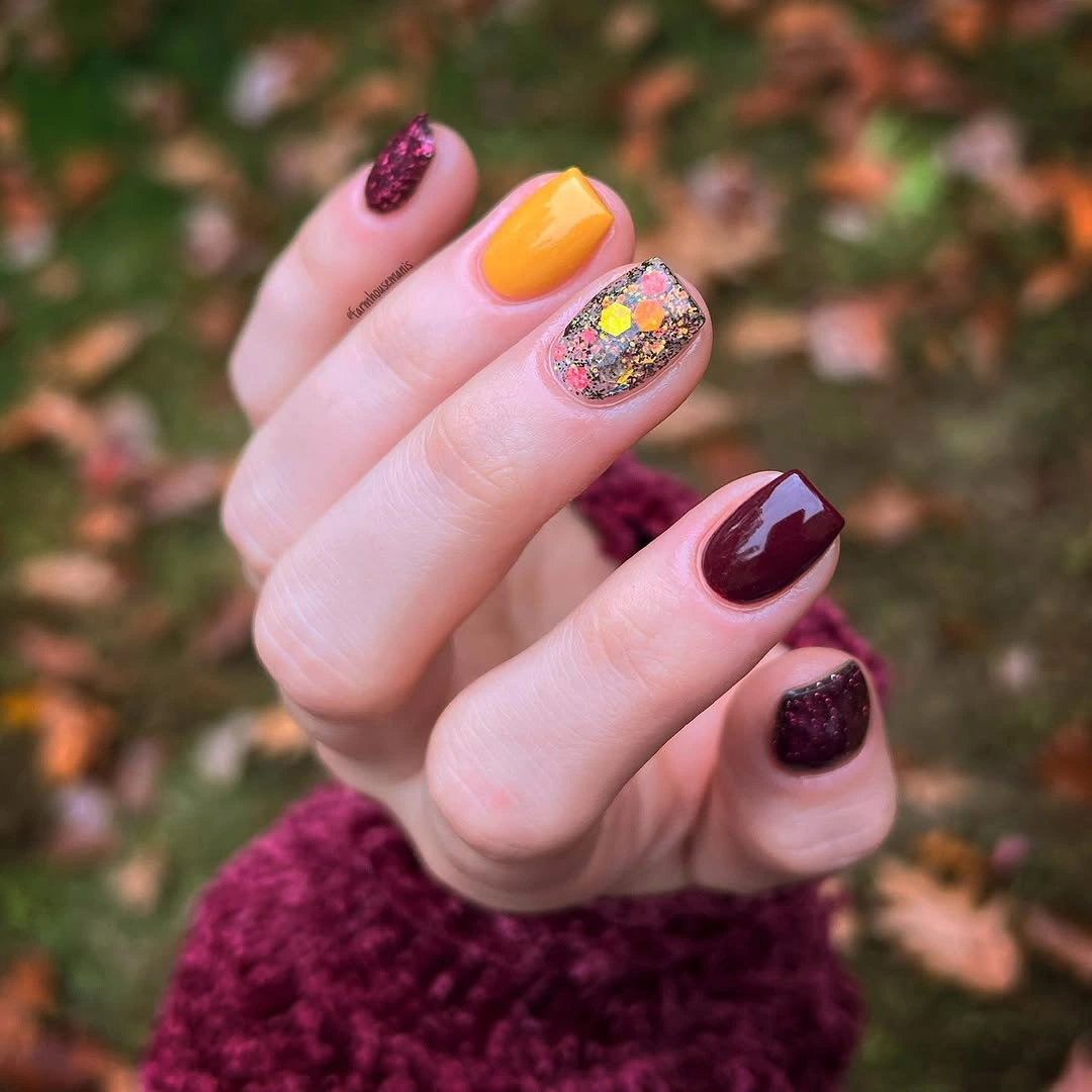 Short square nails in orange berry and plum tones