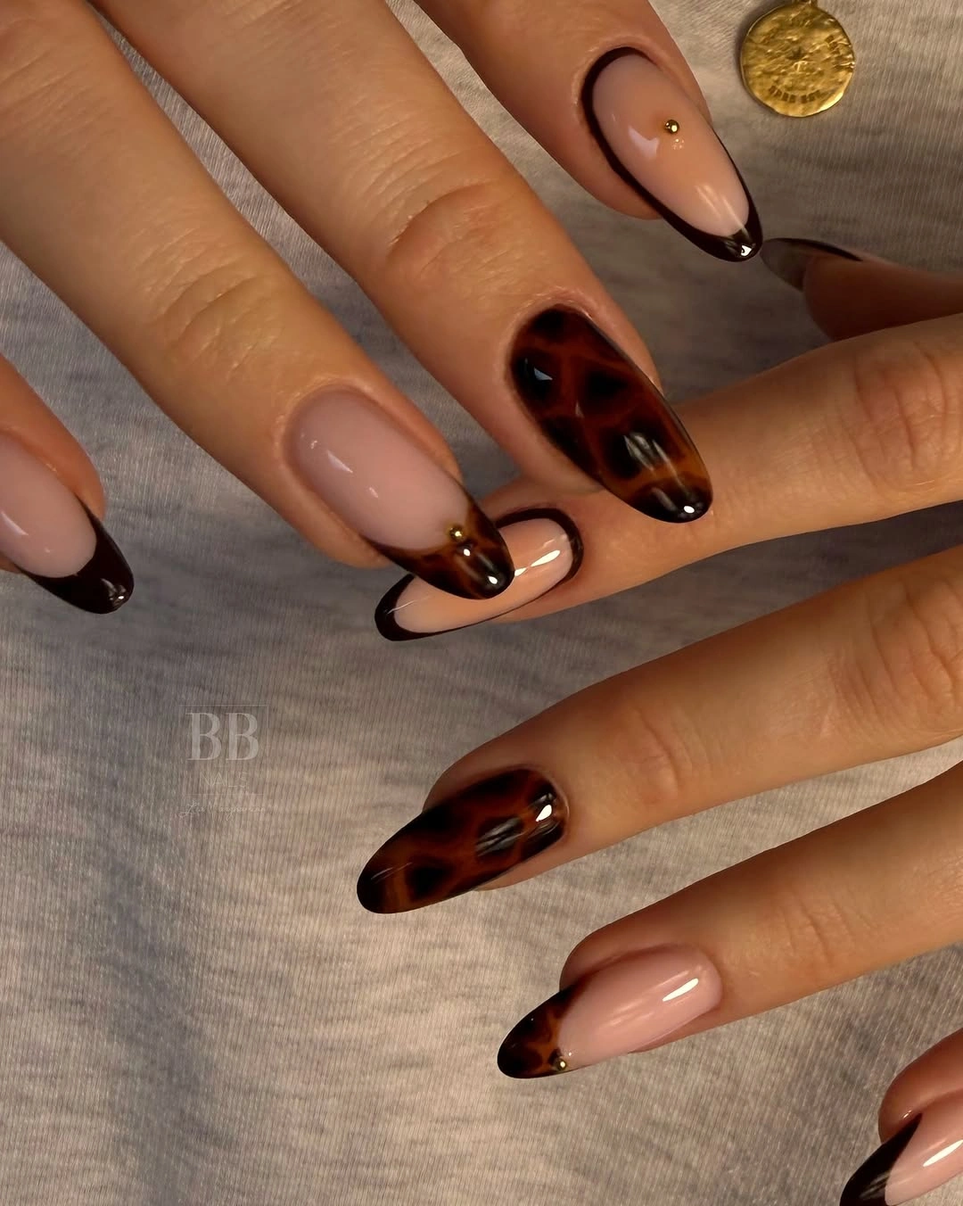 nude almond nails with tortoise brown tips