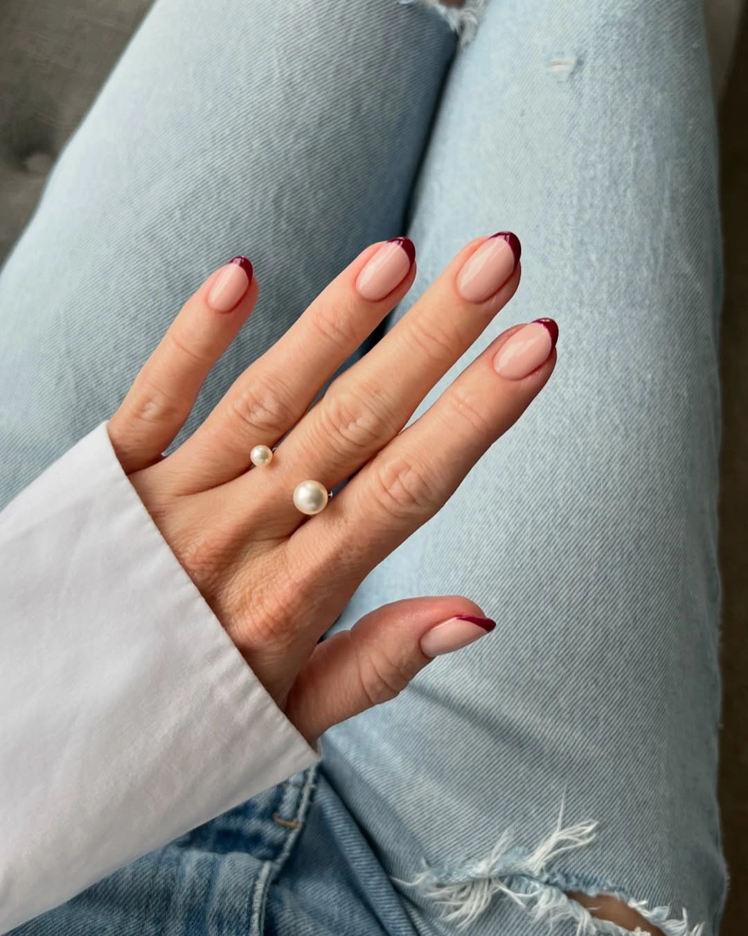 short nude nails with burgundy French tips