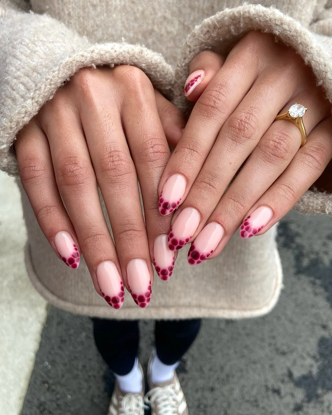 pink French tips with small dark dot accents
