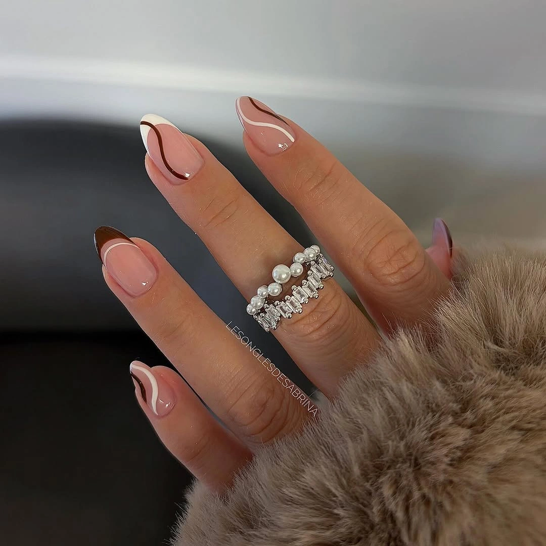 pale pink nails with layered white and brown tips