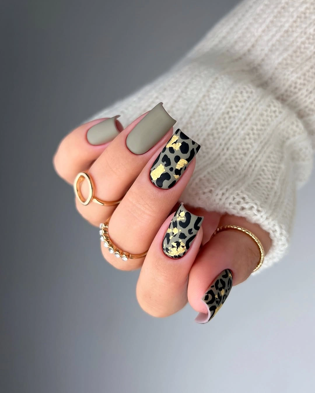 short rounded matte sage nails with patterned accents
