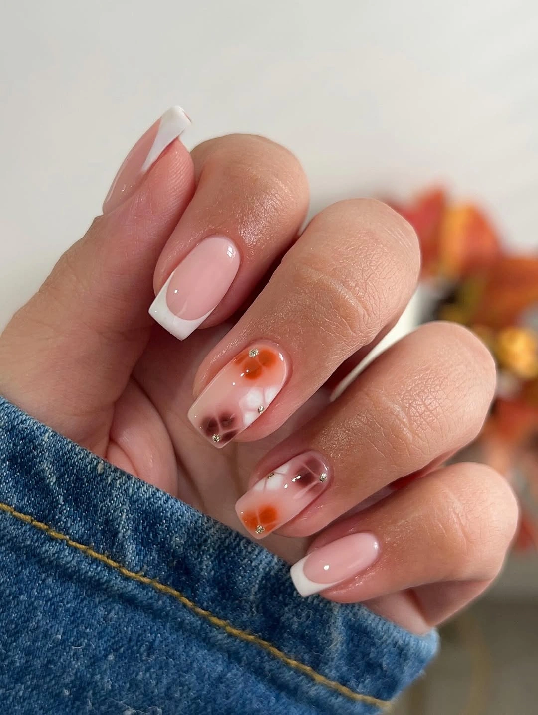 medium almond blush nails with warm abstract accents