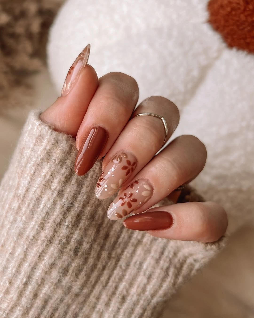 long almond terracotta nails with delicate floral accents