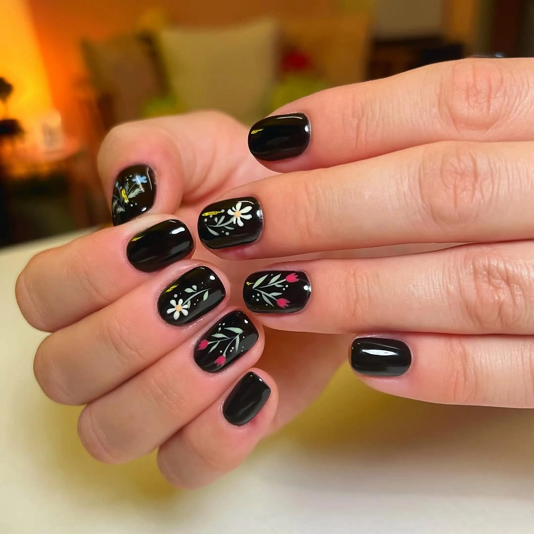 short black nails with small colorful floral details