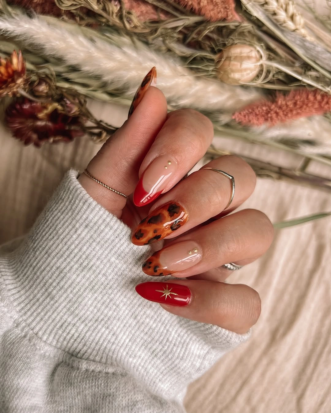 Red almond nails with nude and tortoiseshell-like accents
