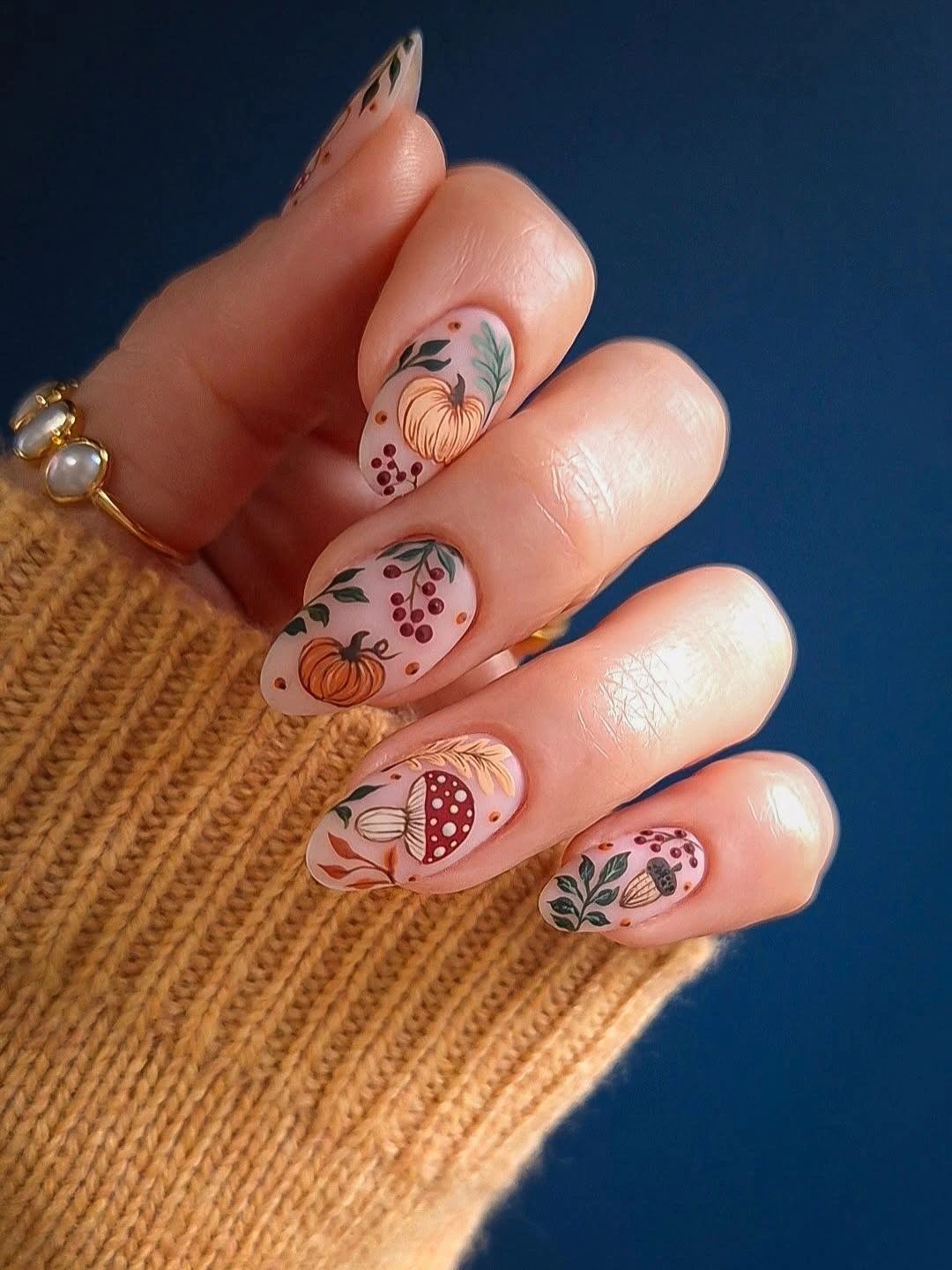 Long pale pink nails with tiny autumn botanical accents