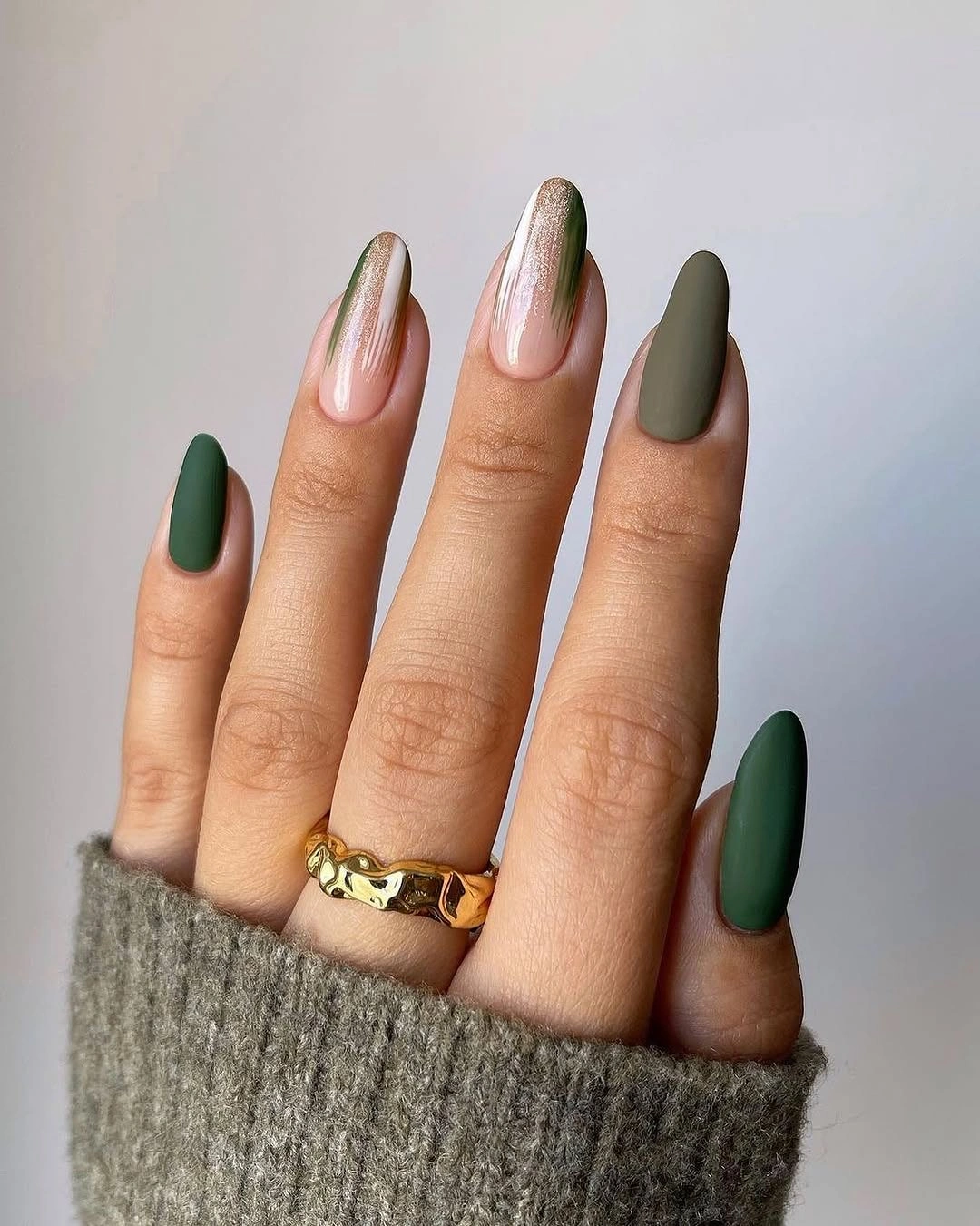 Medium almond nails in forest green sage and pale neutrals
