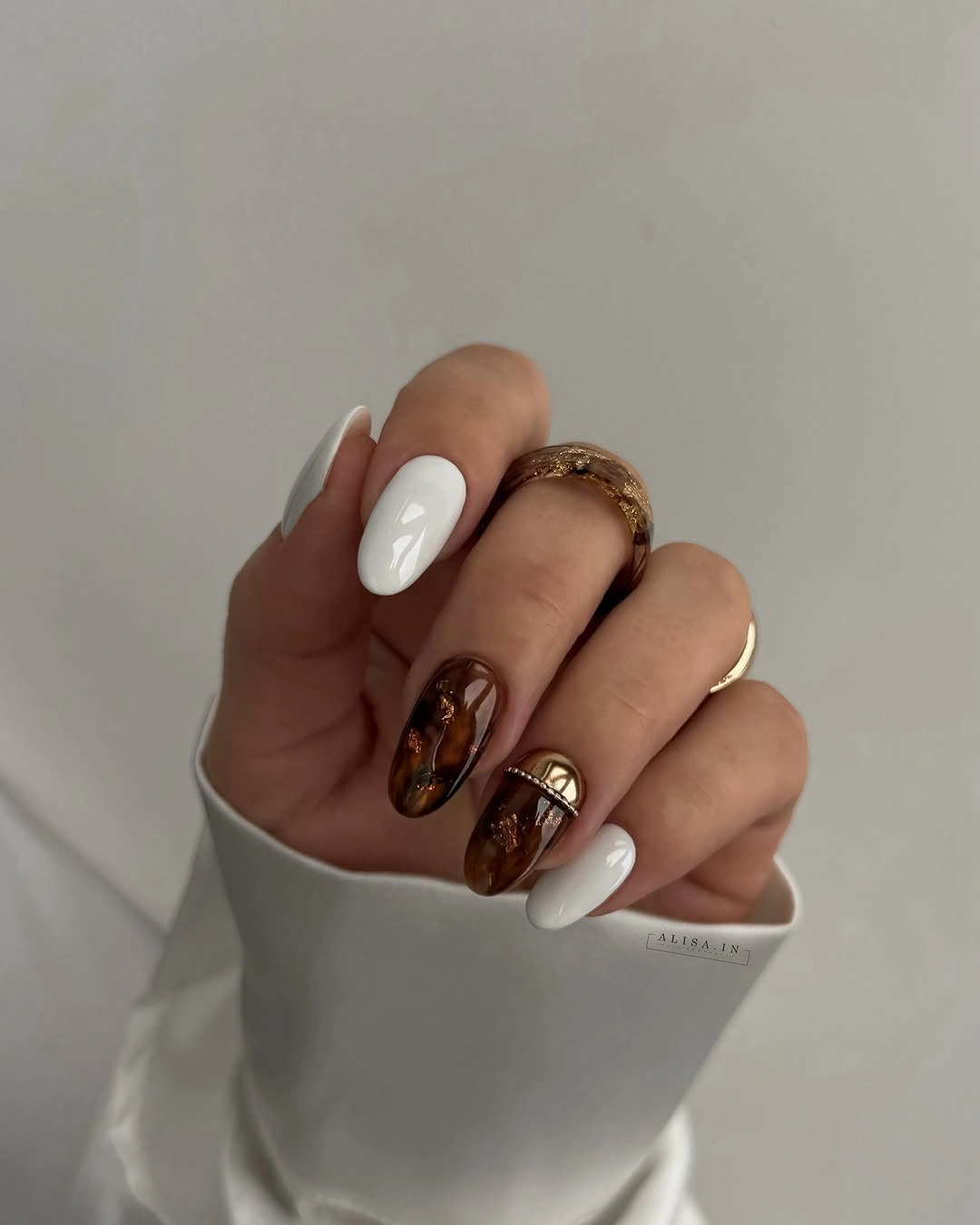 bright orange autumn nails with small floral accents