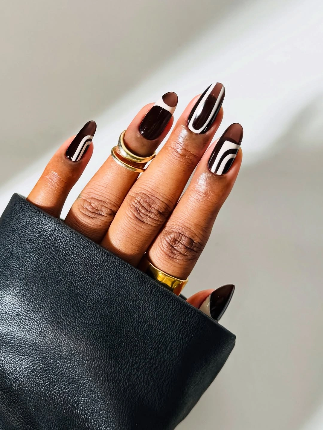 nude nails with olive and brown curved accents