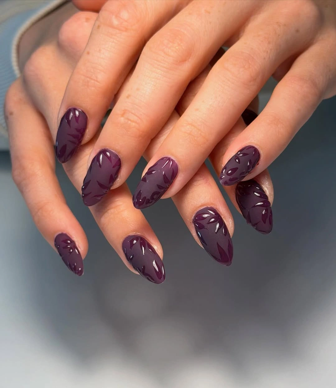 Medium almond nails in tonal purple with subtle strokes