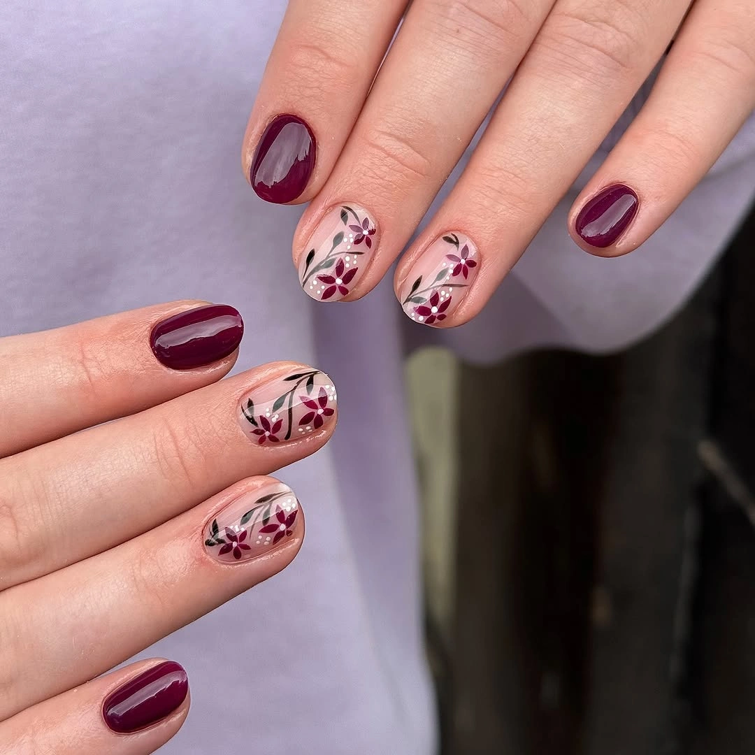 Burgundy medium almond nails with pale floral accents