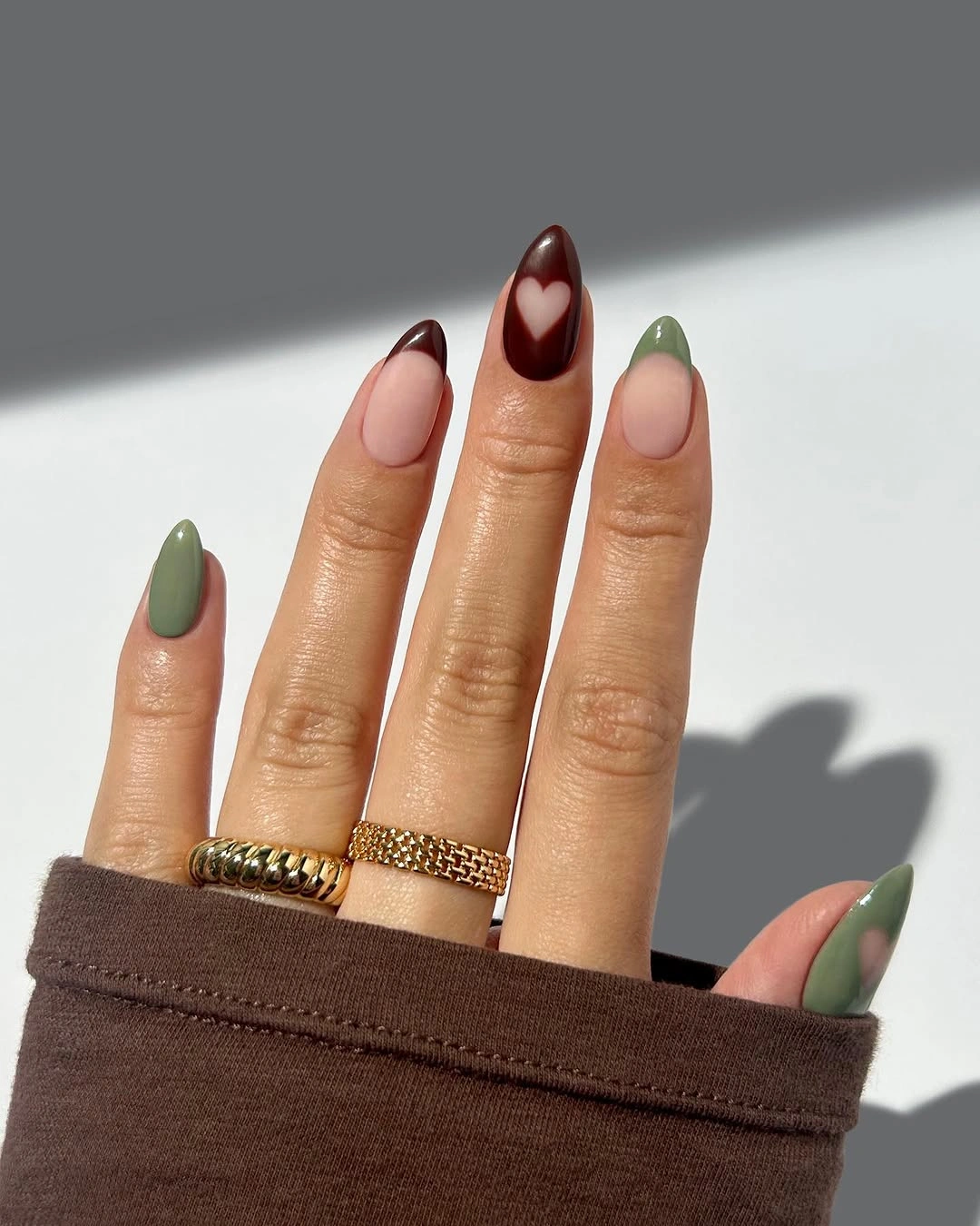 Medium oval olive burgundy nails with heart accent