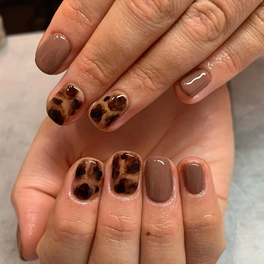 Short square taupe nails with tortoiseshell accents