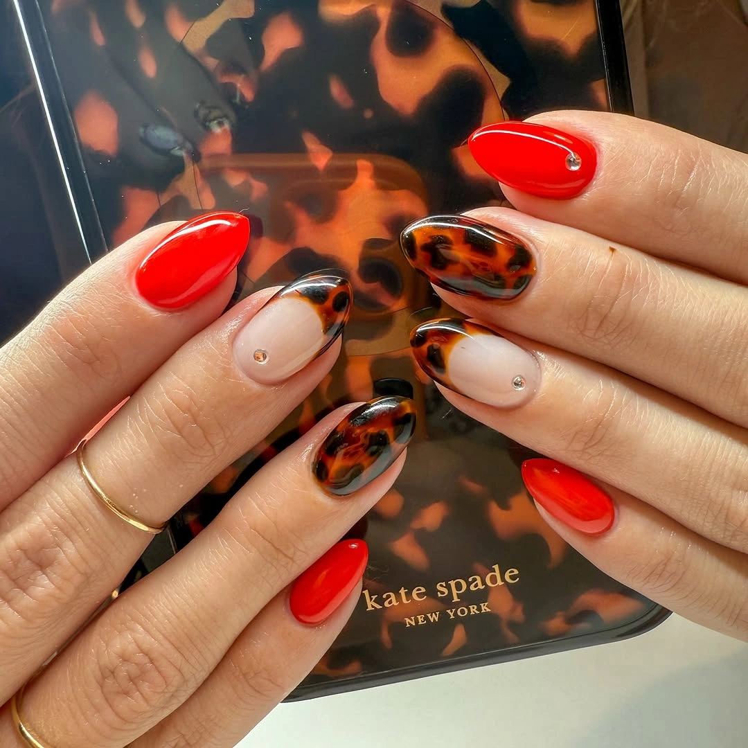 Fall nail idea: long almond red and tortoiseshell negative-space manicure