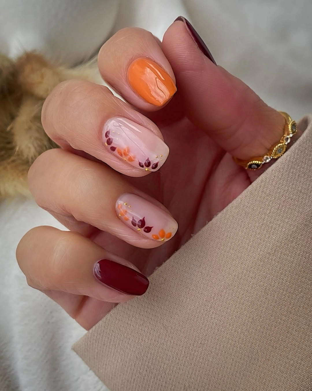 Fall nail idea: short rounded mismatched autumn floral manicure