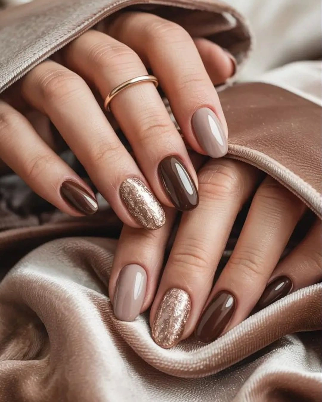 Fall nail idea: medium almond taupe and chocolate manicure with glitter accent