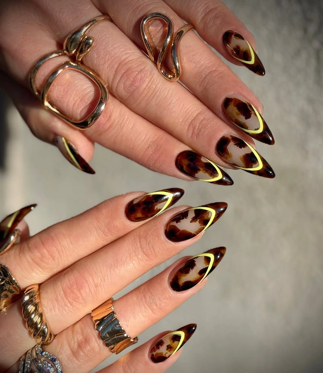 Fall nail idea: long almond tortoiseshell manicure with bright inner outlines