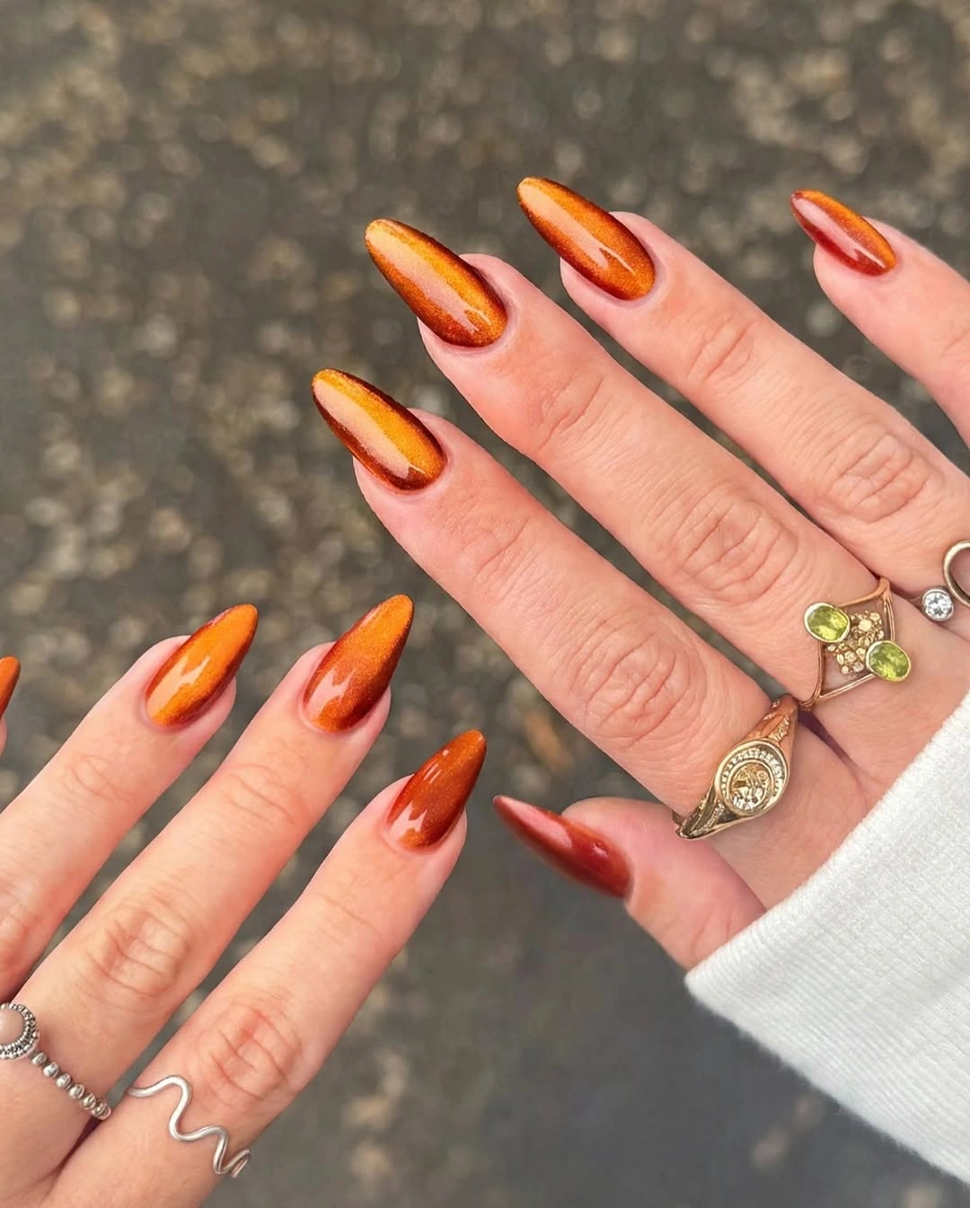 Fall nail idea: long pointed orange-red abstract manicure