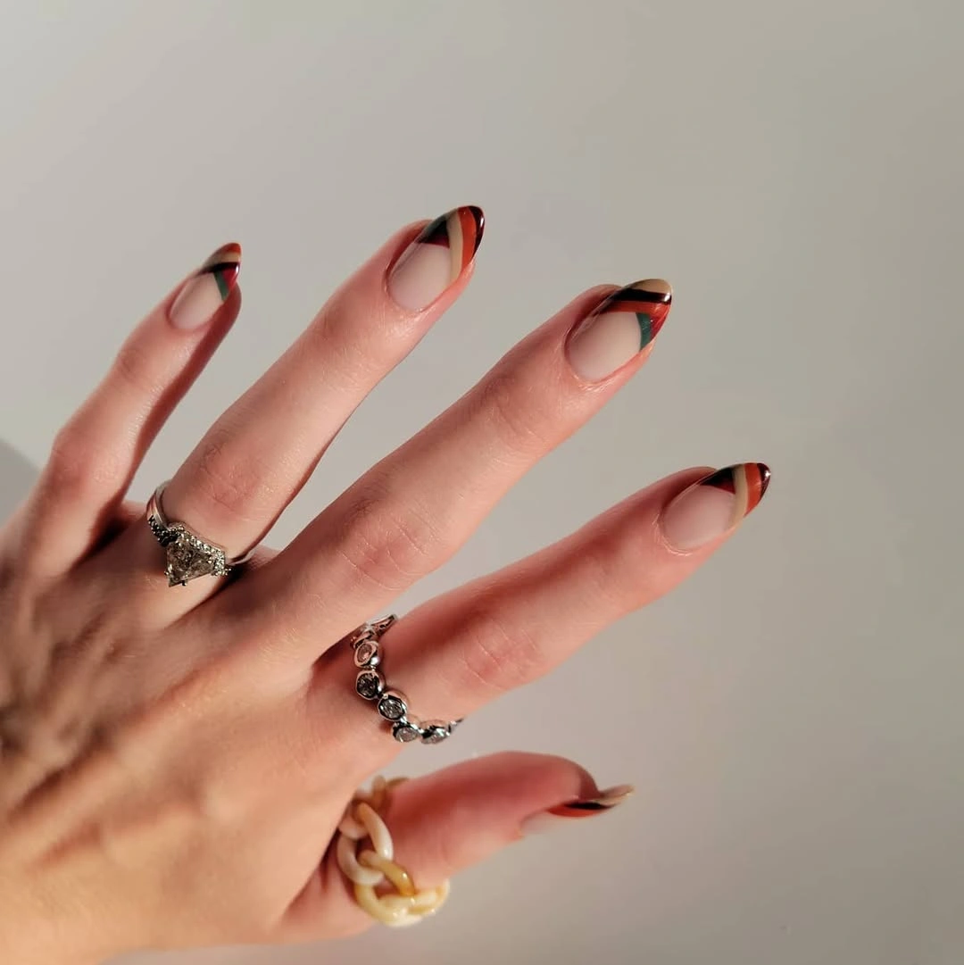 Fall nail idea: medium almond taupe and charcoal manicure with glitter