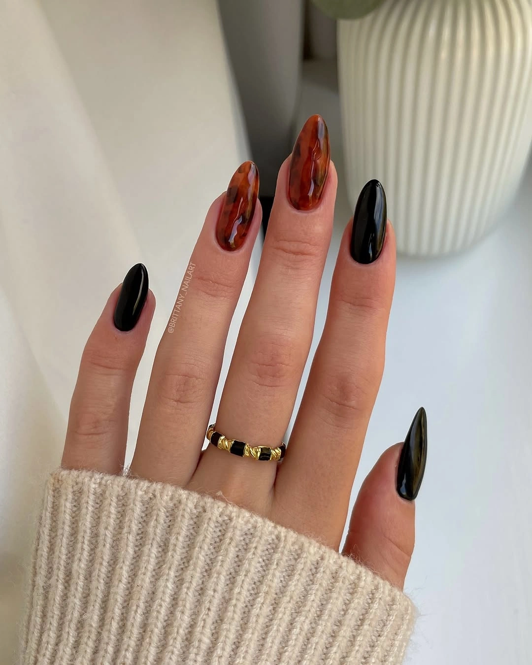 black and burgundy on pointed nails