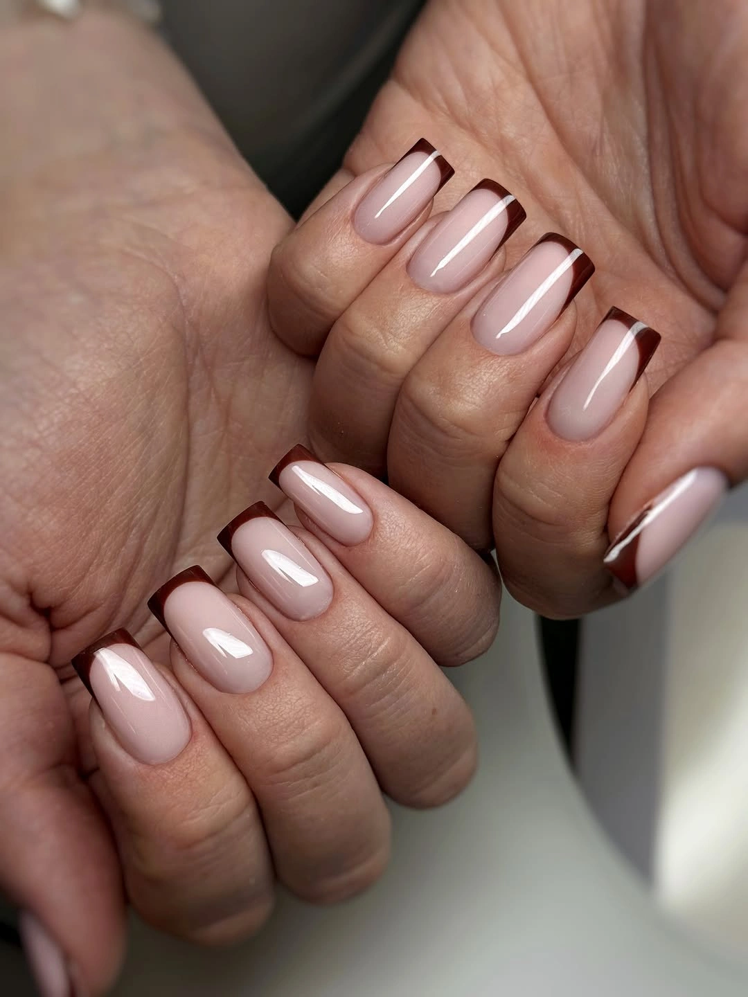 short square pale nails with thin brown French lines