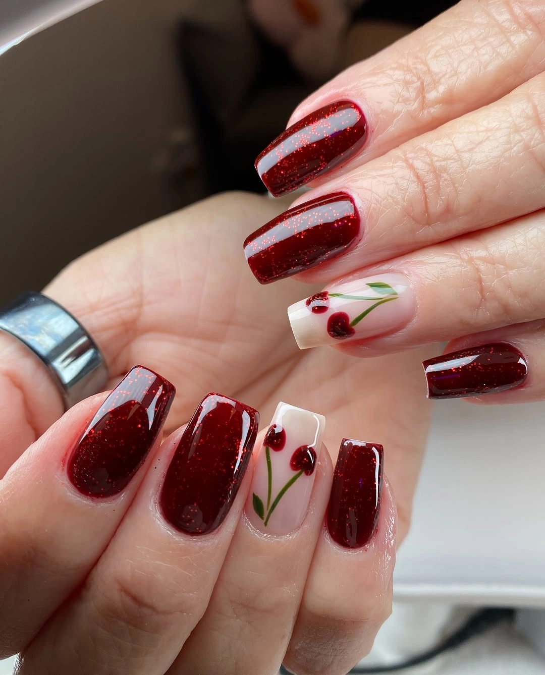 short square red glitter nails with cherry accents