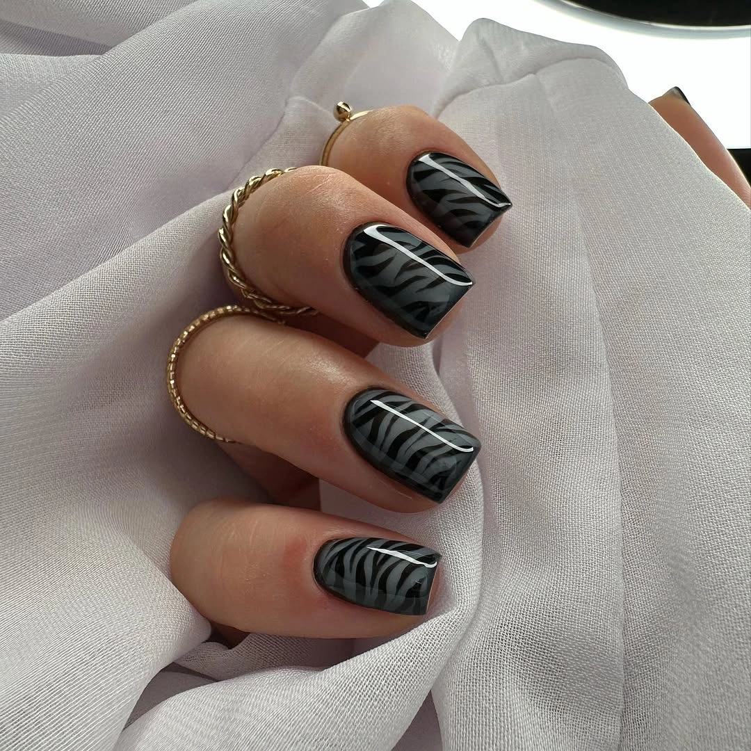 short black square nails with pale wavy stripe details