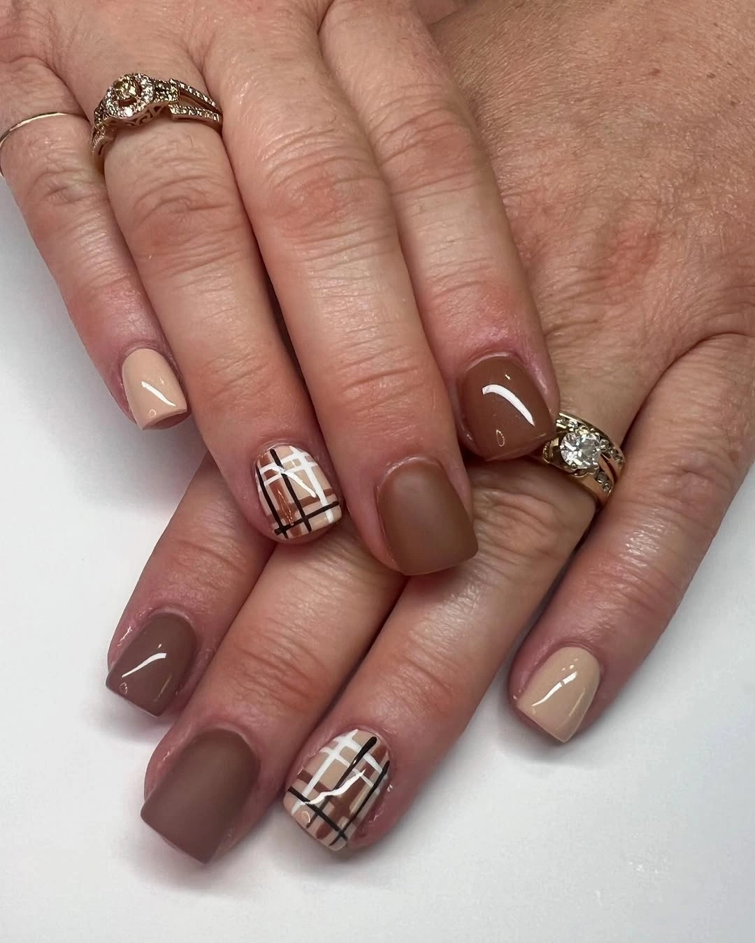 short square taupe nails with a muted plaid accent