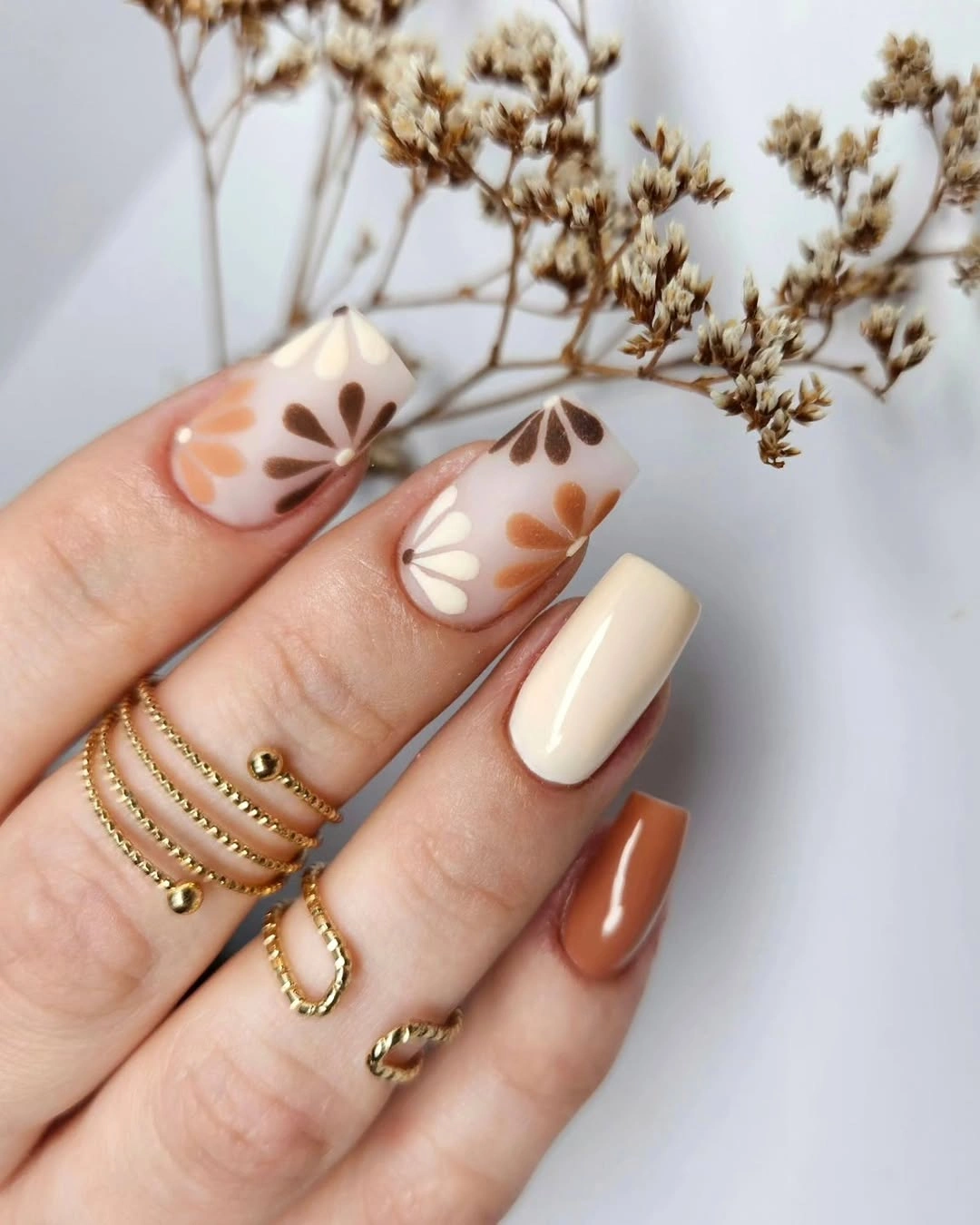 short square cream nails with orange and brown flowers