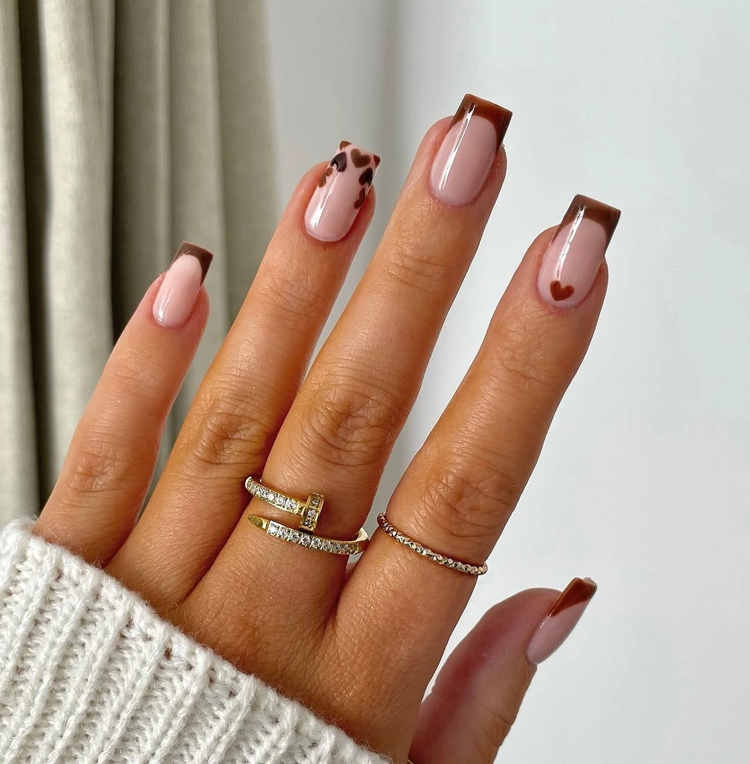 medium square pink nails with brown tips and tiny motifs