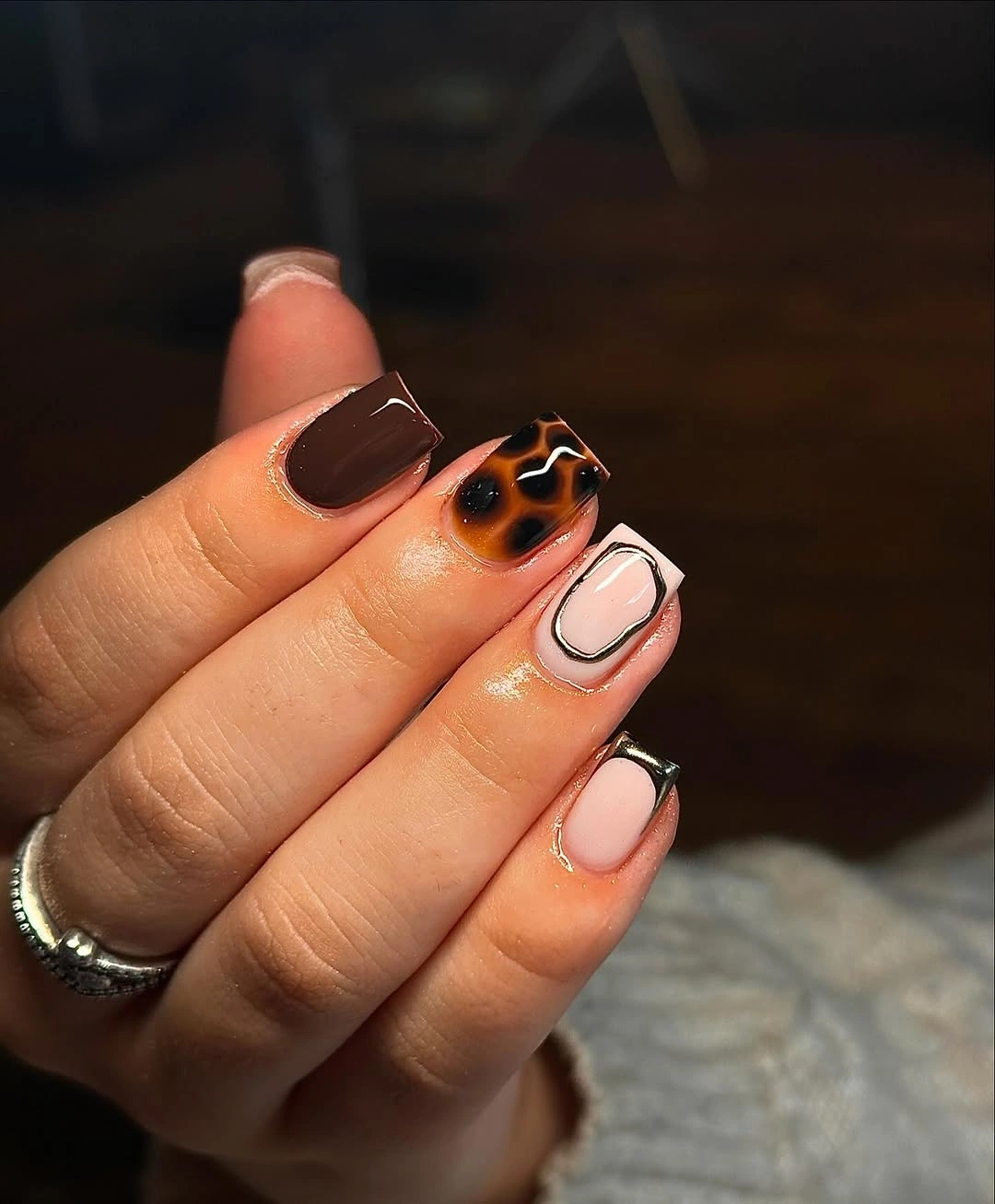 short square dark brown nails with tortoiseshell accents