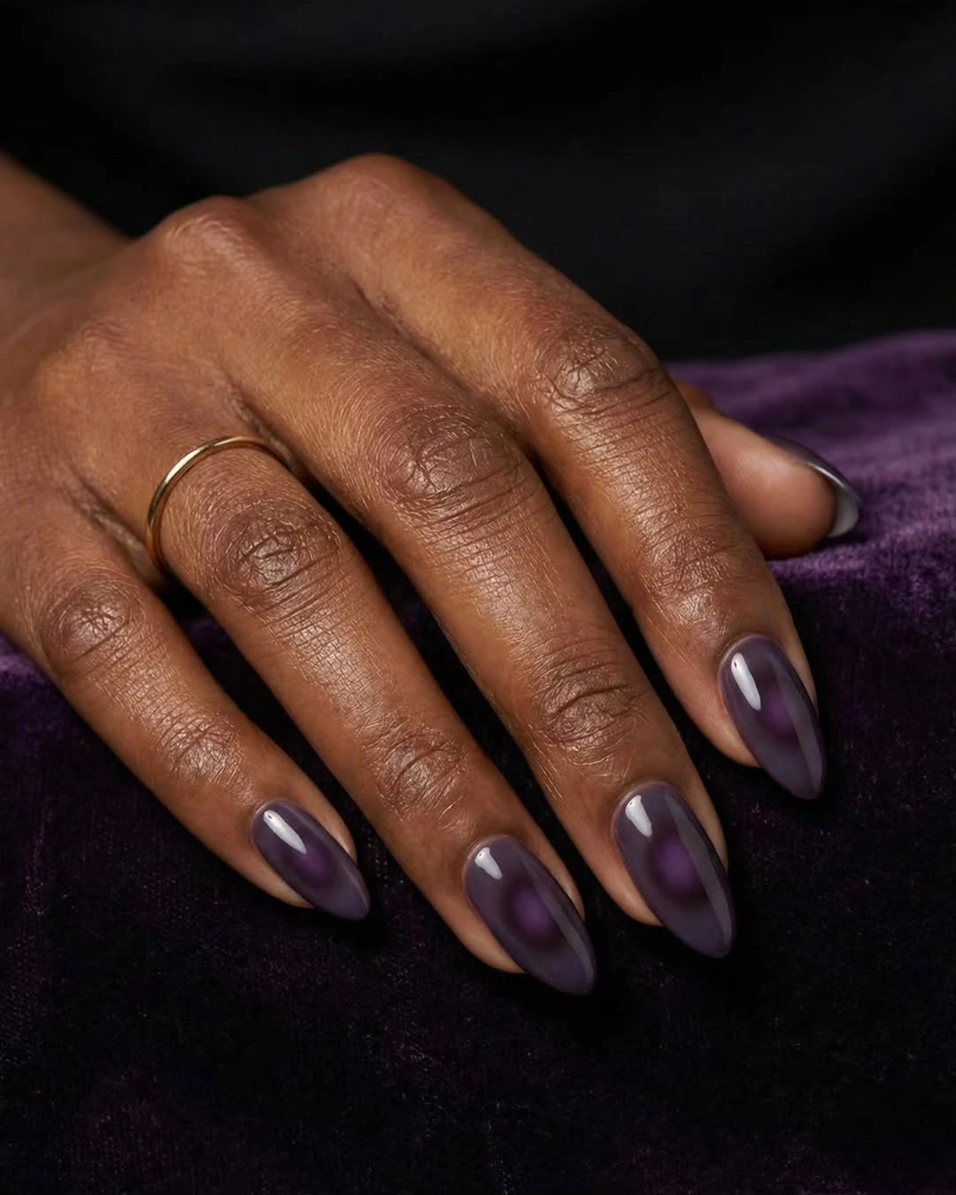 deep plum glossy almond nails on dark skin